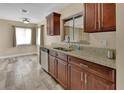 Modern kitchen with granite countertops, stainless steel appliances, and wood-look tile flooring at 1033 Windbrook Dr, Deltona, FL 32725