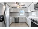 Modern kitchen features white cabinets, stainless steel appliances, and stylish countertops, creating a sleek and functional space at 1135 Holly Ave, Daytona Beach, FL 32117