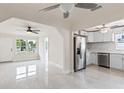 Bright living room with pristine white walls and tile floors offering a seamless transition to the kitchen area at 1135 Holly Ave, Daytona Beach, FL 32117