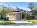 Attractive single-story home featuring a two-car garage and lush landscaping at 118 Grande Belfly Way, Daytona Beach, FL 32124