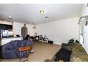 Open living room and kitchen area with tile floors, sofa, and lots of natural light at 1183 Honey Blossom Dr, Orlando, FL 32824