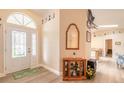 Bright entryway with decorative glass door, wood floors, and transom window at 134 Deskin Dr, South Daytona, FL 32119