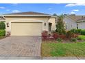 Single-story home with paver driveway, attached garage, and manicured landscaping at 1341 Hayton Ave, Deland, FL 32724