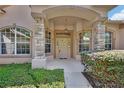 Inviting front porch with stone pillars, arched windows, and a stylish entry door at 1491 W Silver Hammock, Deland, FL 32720