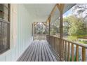 Spacious covered porch with wood railings, offering serene outdoor living at 1712 Alanson Dr, Deland, FL 32724