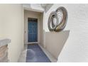 Front door with a Hello mat and decor, leading into a well-lit entryway and a digital access point at 1716 Red Rock Rd, New Smyrna Beach, FL 32168