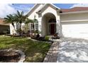 Charming home with a well-kept lawn, beautiful landscaping, and an attached two-car garage at 1751 Creekwater Blvd, Port Orange, FL 32128