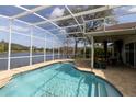 Inviting screened-in pool area with a view of the lake, perfect for outdoor entertaining and relaxation at 1751 Creekwater Blvd, Port Orange, FL 32128