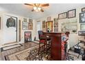 A well-decorated bar area with unique decor, a ceiling fan, and wood-look vinyl floors at 1930 S Clara Ave, Deland, FL 32720
