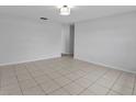 Spacious living room with neutral tile flooring and modern lighting at 1986 Big Oak Dr, South Daytona, FL 32119