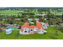 Beautiful oceanfront home featuring a pool, lush landscaping, and a stunning terracotta tile roof at 201 Ocean Shore Blvd, Ormond Beach, FL 32176
