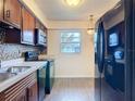 Functional kitchen featuring sleek black appliances, mosaic backsplash, and ample cabinet space at 202 Oakleigh Dr # 90, Deland, FL 32724