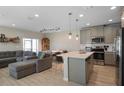 Inviting open-concept living space with island seating and ample natural light at 206 Beautyberry Ln, Sanford, FL 32771