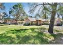 Spacious backyard with mature trees providing ample shade, perfect for outdoor activities at 230 White Dove Ave, Orange City, FL 32763
