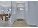 Inviting foyer with tiled flooring, a decorative front door, and natural light at 230 White Dove Ave, Orange City, FL 32763