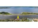 Stunning aerial view of waterfront property with the home nestled among mature trees at 2852 John Anderson Dr, Ormond Beach, FL 32176