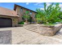 Elegant brick driveway leading to a well-maintained brick home with a spacious garage at 2852 John Anderson Dr, Ormond Beach, FL 32176