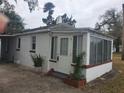 View of the backyard featuring a small concrete patio and white brick exterior walls at 333 8Th St, Daytona Beach, FL 32117