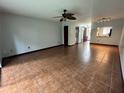 Spacious living room with tile flooring, ceiling fan, and light blue walls at 3960 Willow Trail Run # 45, Port Orange, FL 32127