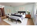 Serene main bedroom with a king bed, stylish decor, and a cozy seating area for relaxation at 3960 Willow Trail Run # 45, Port Orange, FL 32127