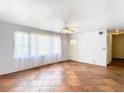 Bright living room with tiled floors, neutral walls, and sheer curtains that filter soft natural light at 410 Riverview Blvd, Daytona Beach, FL 32118