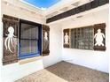 Unique porch detailing with custom shutters featuring nautical-themed designs and decorative glass block window at 410 Riverview Blvd, Daytona Beach, FL 32118