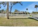 Traditional home with a white picket fence and mature trees providing a picturesque curb appeal at 435 N Oak Ave, Orange City, FL 32763