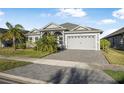 Attractive single-story home with a paver driveway and manicured lawn, offering great curb appeal at 6263 W Fallsgrove Ln, Port Orange, FL 32128