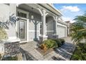 Inviting front entrance with decorative glass door, stone accents, and a paved walkway at 6263 W Fallsgrove Ln, Port Orange, FL 32128
