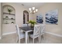 Cozy dining room featuring neutral decor, elegant light fixture, and niche shelving at 903 Victoria Hills S Dr, Deland, FL 32724