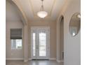 Bright foyer showcasing a decorative glass front door, arched doorways and a stylish light fixture at 903 Victoria Hills S Dr, Deland, FL 32724