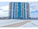 Exterior of condominium building with balconies and view from the roof, showing tennis court and helipad at 925 N Halifax Ave # 910, Daytona Beach, FL 32118
