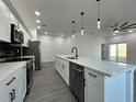 Well-equipped kitchen featuring a large island with sink, stainless steel appliances, and modern backsplash at 955 Redwood St, Daytona Beach, FL 32117