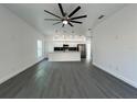 Bright, open-concept living space with modern finishes, sleek flooring, and a kitchen island with pendant lighting at 955 Redwood St, Daytona Beach, FL 32117