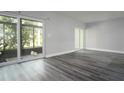 Bright living room featuring modern gray floors, sliding glass doors, and ample natural light at 100 Sweetgum Woods Ct # 10C, Deltona, FL 32725