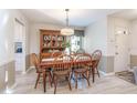 Traditional dining room with wooden table, chairs, hutch, and decorative lighting fixture at 101 Grand Plaza Dr # M1, Orange City, FL 32763