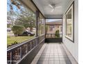 View of screened porch featuring decorative tile flooring and ceiling fan at 102 Underbrush Trl, Port Orange, FL 32128