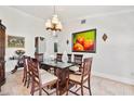 Elegant dining room featuring a glass-top table, carved wood chairs, and a decorative chandelier at 1058 W Seagate Dr, Deltona, FL 32725