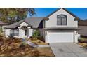 Beautifully landscaped home exterior with a two-car garage and gray roof at 1062 Golf View Estates Dr, Orange City, FL 32763