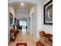 Hallway showing the open floor plan that leads to a screened in porch, and light-colored tiled flooring at 107 Gladesdown Ct, Deland, FL 32724