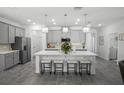 Modern kitchen with a large center island, pendant lighting, and stainless steel appliances at 1088 Happy Forest Loop, Deland, FL 32720