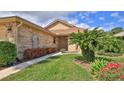 Beautiful home exterior showcasing lush landscaping with colorful flowers along the walkway at 111 Brown Crane Ct, Daytona Beach, FL 32119