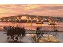 Community pool featuring nearby bridge at sunset, including lounge furniture and water features at 1224 S Peninsula Dr # 210, Daytona Beach, FL 32118