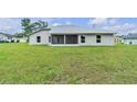 Spacious backyard featuring a screened patio and ample green space at 1329 N Old Mill Dr, Deltona, FL 32725