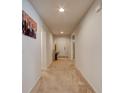Inviting hallway with neutral paint, arched doorways and carpet flooring throughout at 1423 Chelsea Manor Cir, Deland, FL 32724