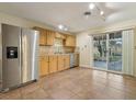 Kitchen with stainless steel appliances, tile backsplash, and sliding door access to backyard at 1493 Derbyshire Rd, Daytona Beach, FL 32117