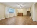Spacious living room featuring tile flooring, natural light, and direct access to the front door at 1493 Derbyshire Rd, Daytona Beach, FL 32117