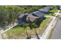 Aerial view of a quaint home, showcasing its unique architecture and well-landscaped yard at 1572 Darlington Ave, Deltona, FL 32725