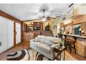 Inviting living room with a plush sofa, wooden accents, and views of the staircase at 1572 Darlington Ave, Deltona, FL 32725