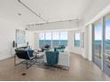 Open-concept living space with ocean view and modern furnishings, light colored walls and tile flooring at 1900 N Atlantic Ave # 504, Daytona Beach, FL 32118